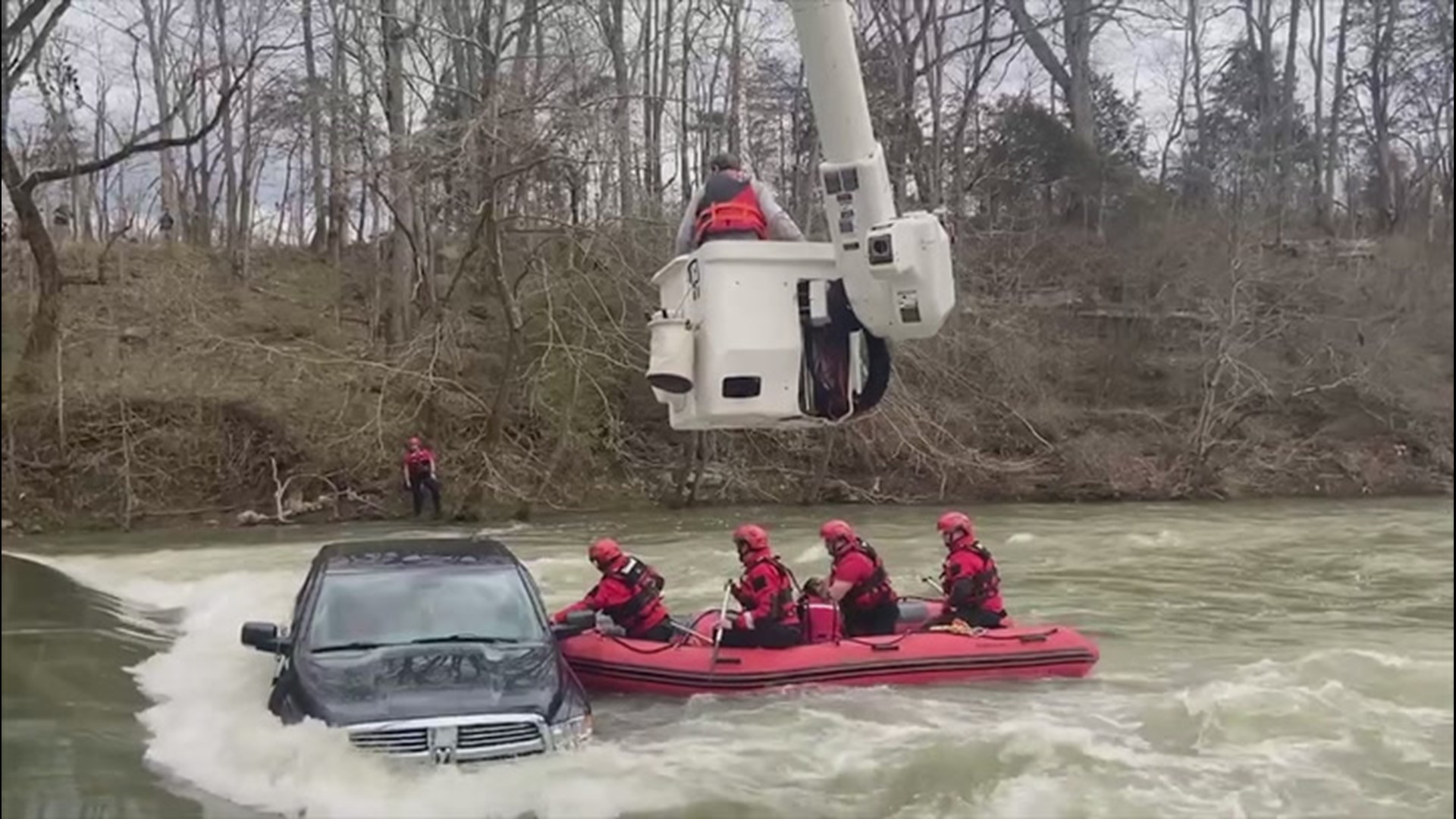 Swift-water rescue teams, with the help of bucket trucks from local phone and electric companies, saved a family, including an infant, from a partially submerged vehicle near Liberty, Tennessee.