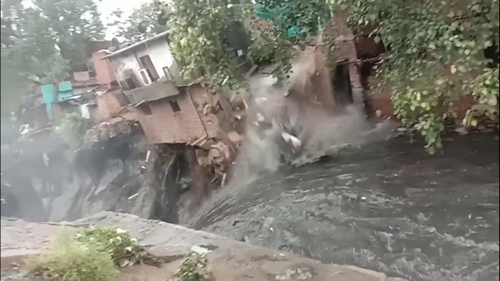 Heavy rain and flooding brought a two-story building crashing down in New Delhi, India, on July 19, as storms lashed the area.