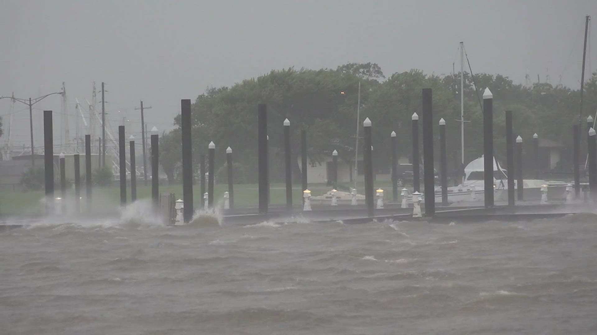 Hurricane Beryl storm surge pushing water over sea wall on