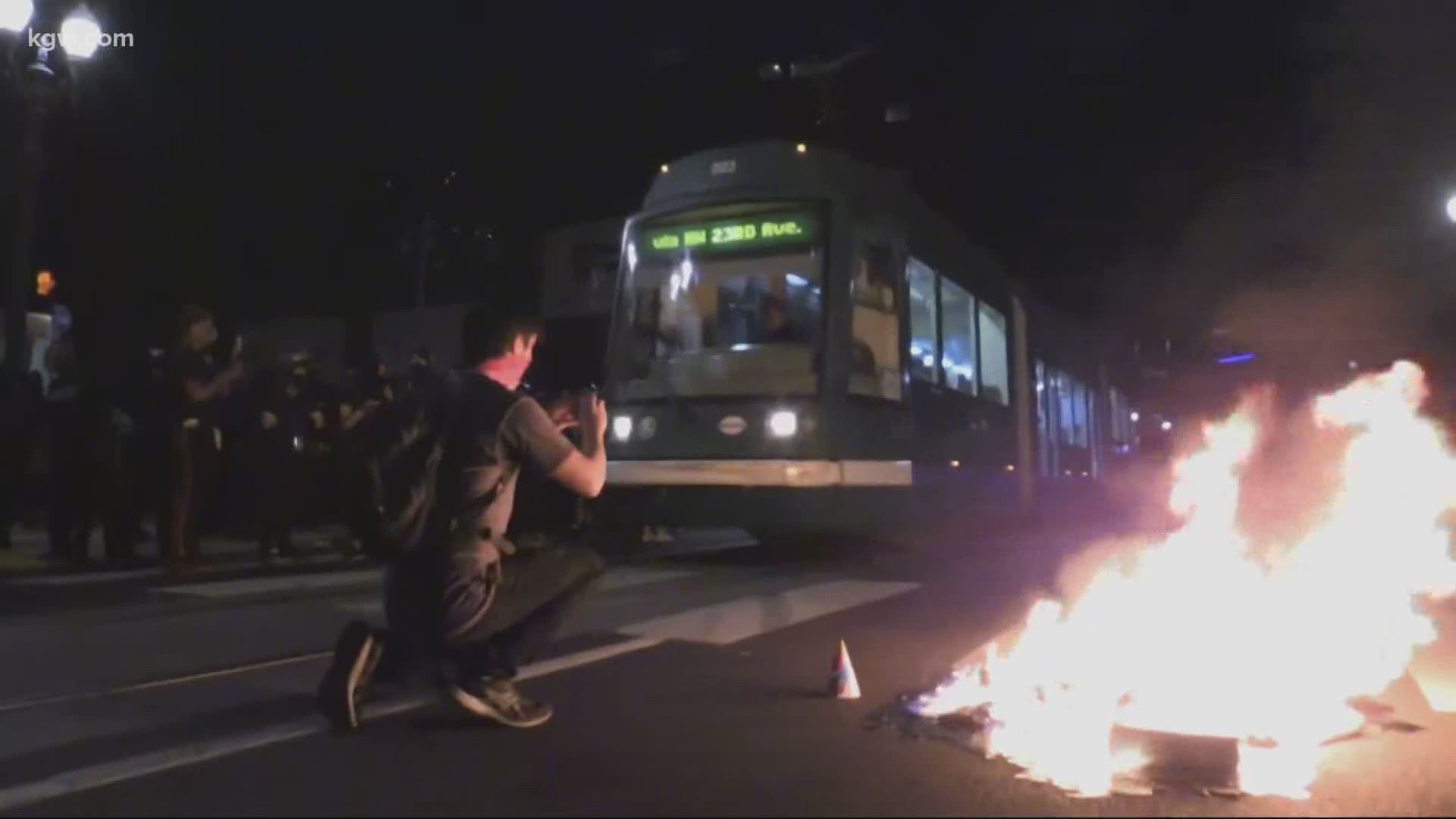 Police respond after riot is declared outside Portland Mayor Ted Wheeler’s apartment late Monday night.