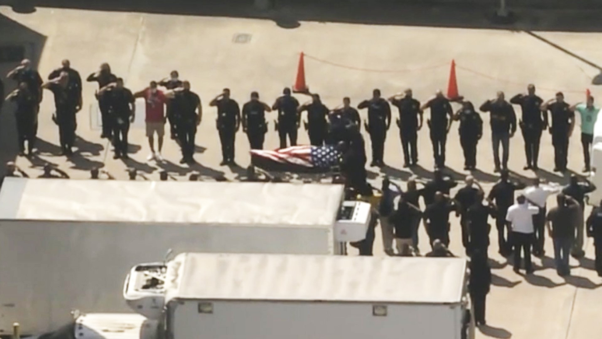 An American flag was draped over the casket of fallen HPD officer William 'Bill' Jeffery as it was removed from a hearse at the medical examiner's office.