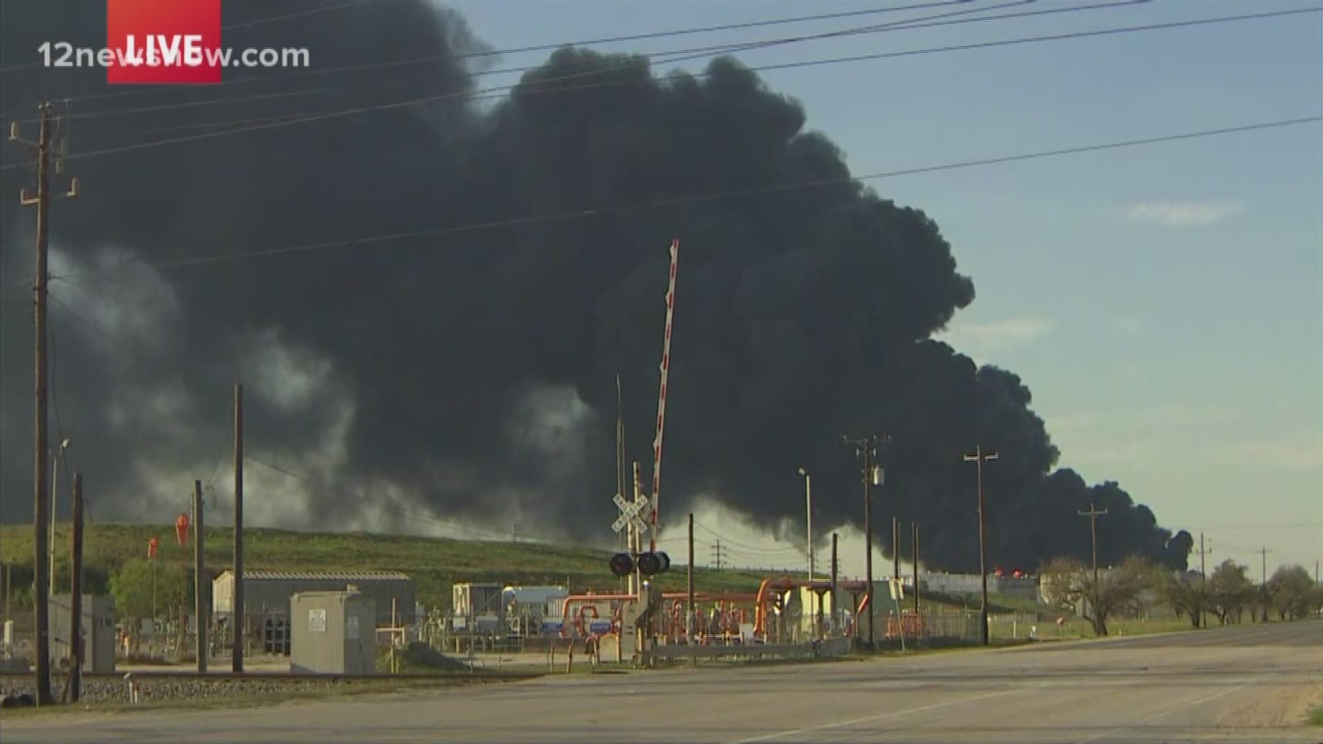 Black smoke continues to pour from multiple tanks in the facility.
