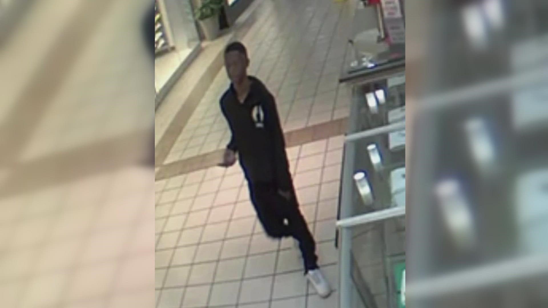 The unidentified young man was caught on surveillance cameras kicking in a glass display case.