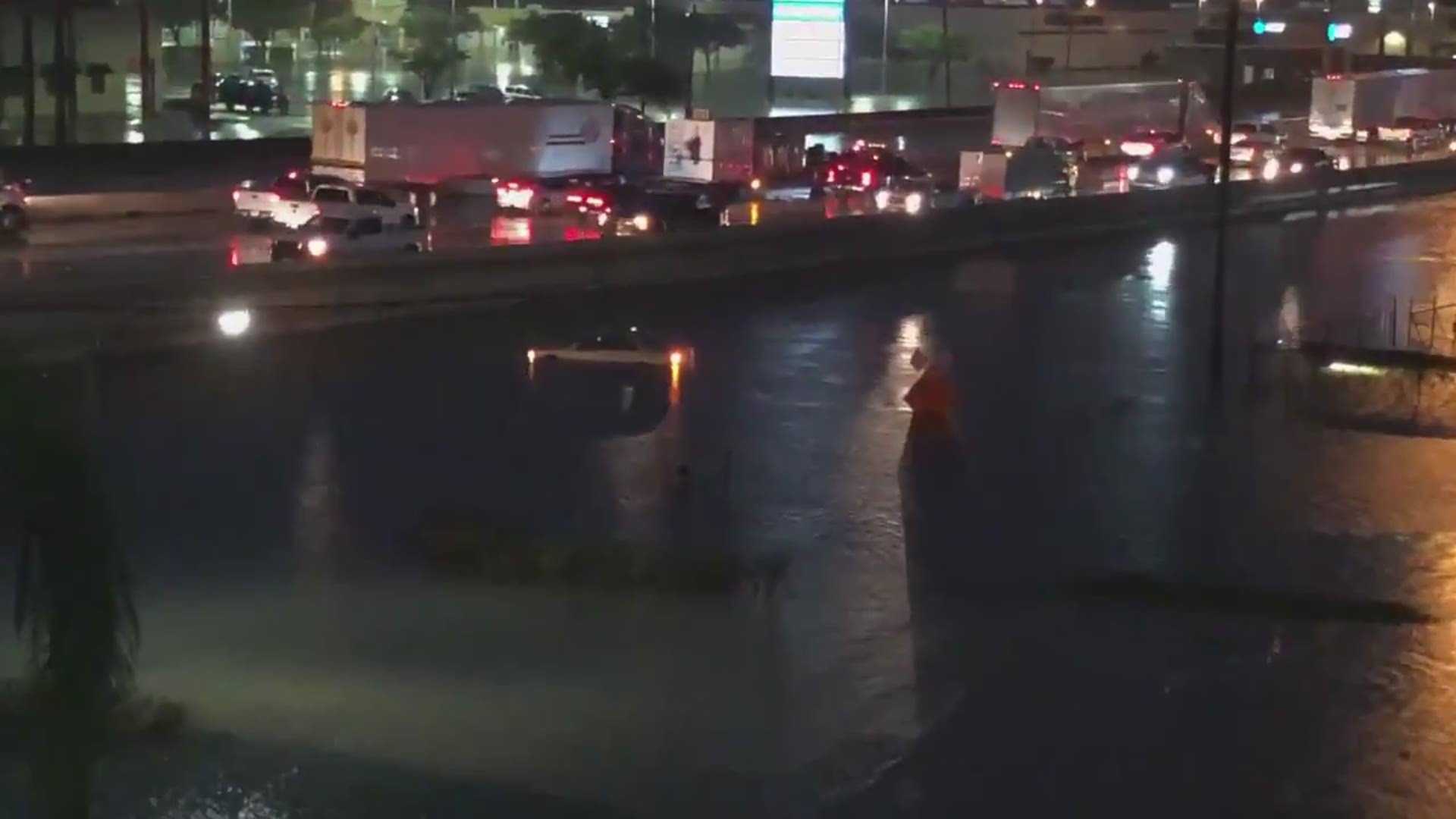 A view of I-10 westbound in Beaumont from 40 feet in the air shows traffic at a standstill and multiple roadways completely submerged.