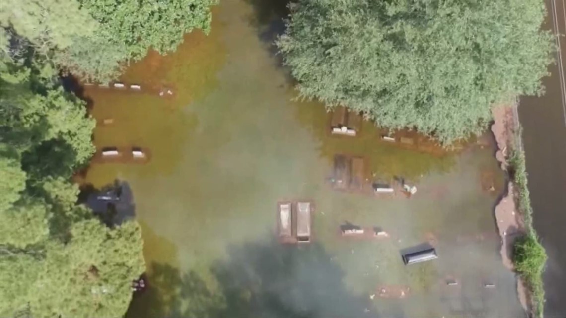 Coffins float at Orangefield cemetery during Imelda's flooding ...