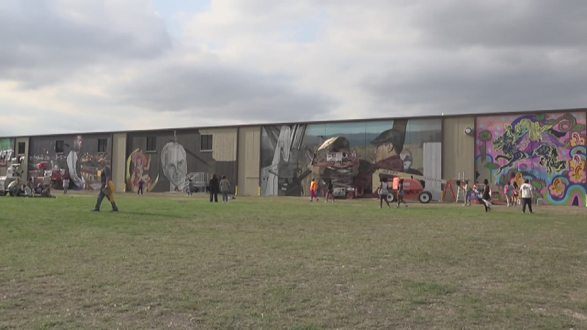 The artists showcased their painting skills using both oversized wooden cubes and the walls of the building as their canvas.