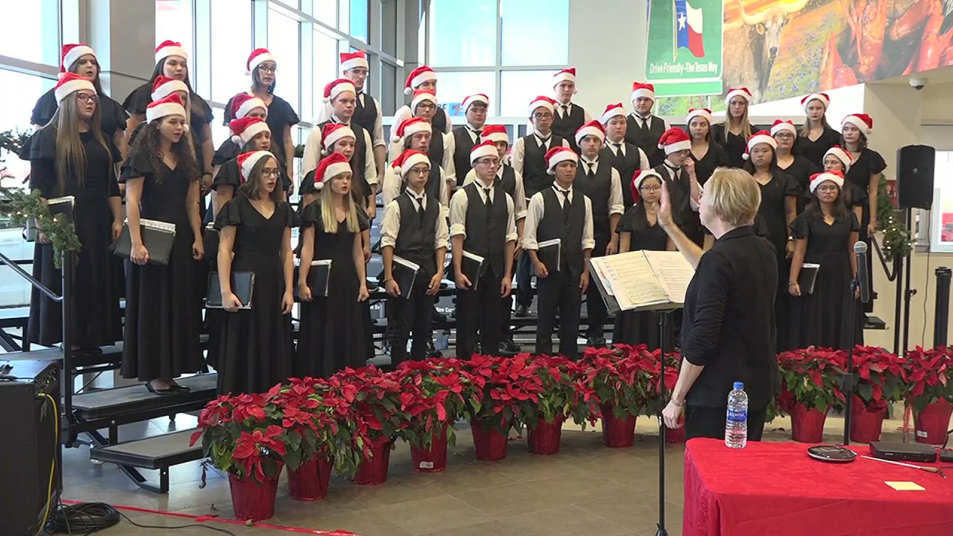 Nederland High School Choir performs at Kinsel Toyota as part of Parade of Christmas Choirs