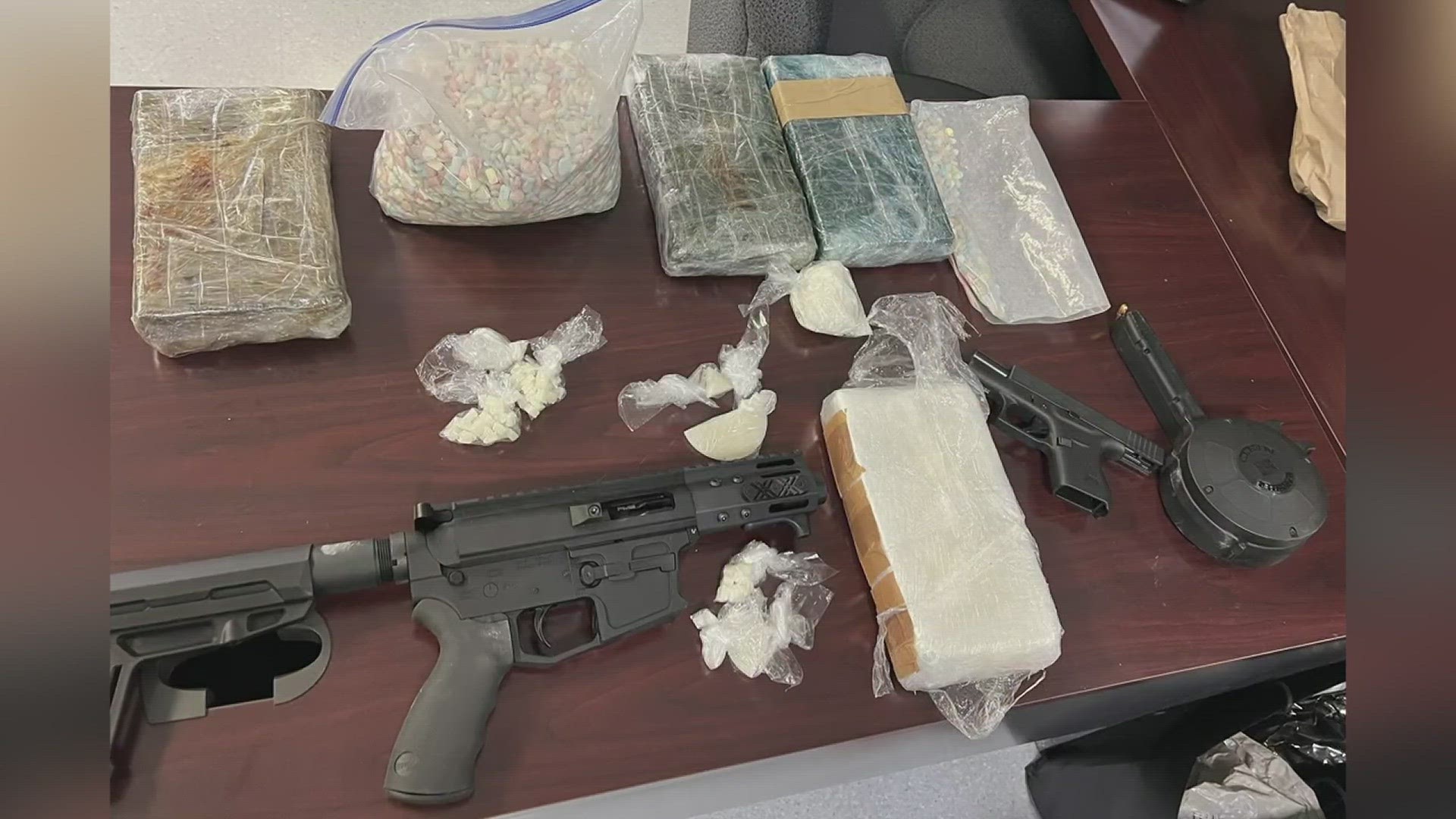 Detectives found more than 4 kilograms of powder cocaine, 3 pounds of ecstasy tablets and two guns inside the residence, according to the release.