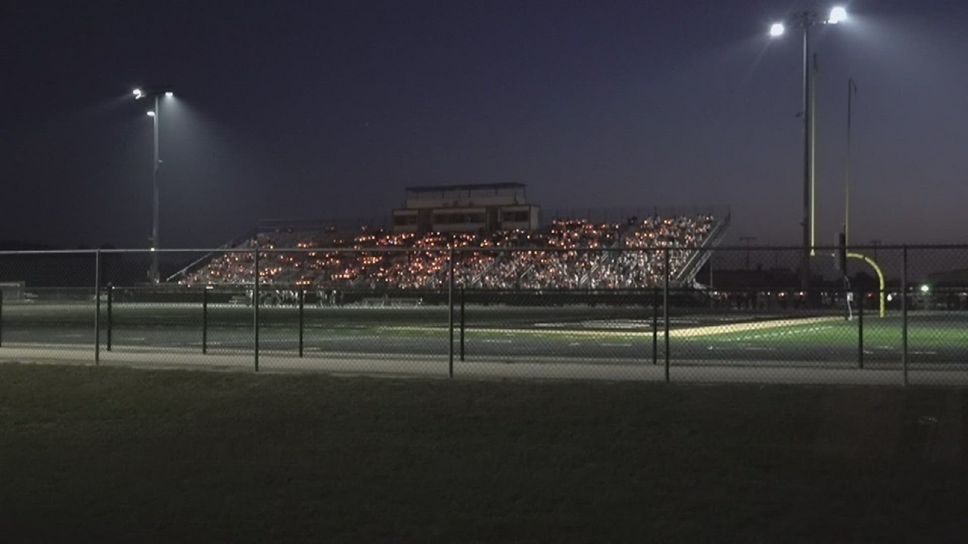 The community held a candlelight vigil Sunday night at Kyle White Stadium at Anahuac High School for two of the students who were killed Saturday night in a wreck.