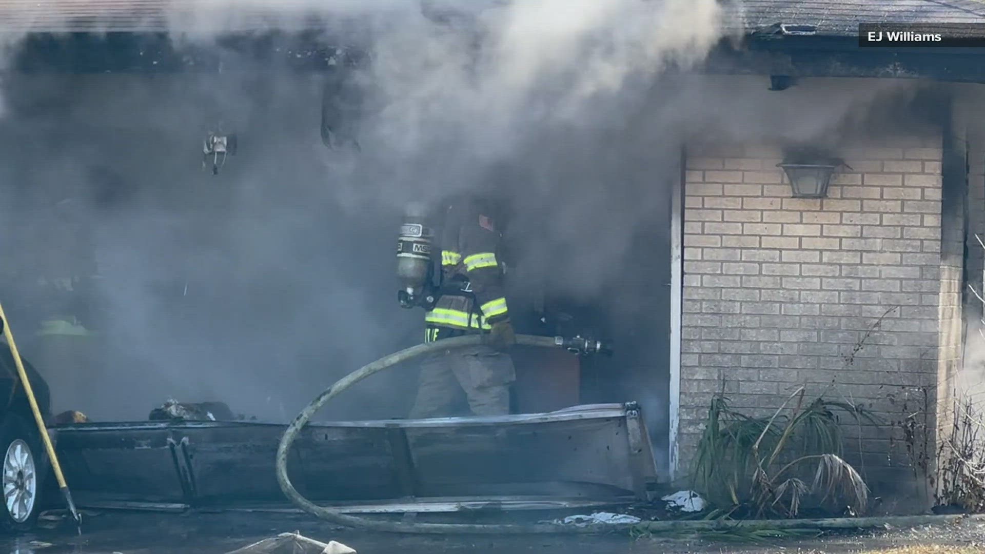 Two people in the house heard a loud pop and then looked in their garage where they saw it was on fire.