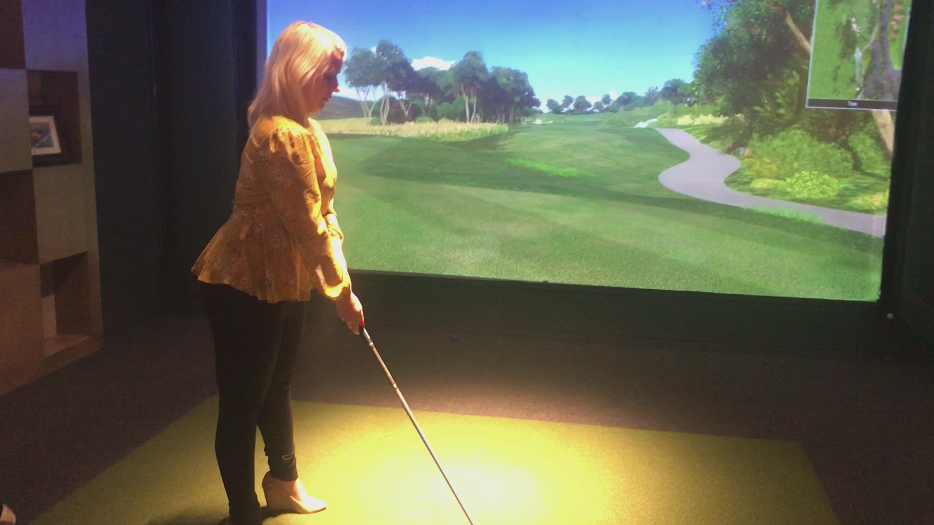 The interactive golf game lets you hit a golf ball at a virtual screen