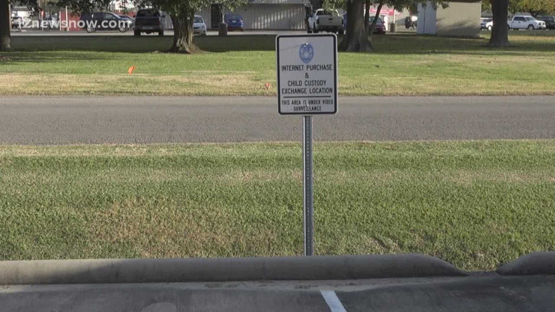 A sign outside the Groves Police Department designates an area for people to safely exchange items bought online as well as custody of children under 24/7 surveillance.