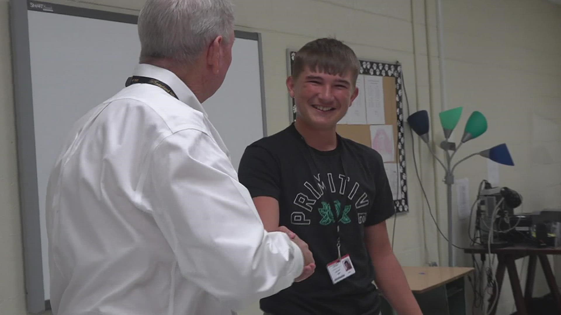 Superintendent Dr. Stuart Kirschnick awarded Jackson Winfree a hat and t-shirt for being the first student to arrive on the first day of school.