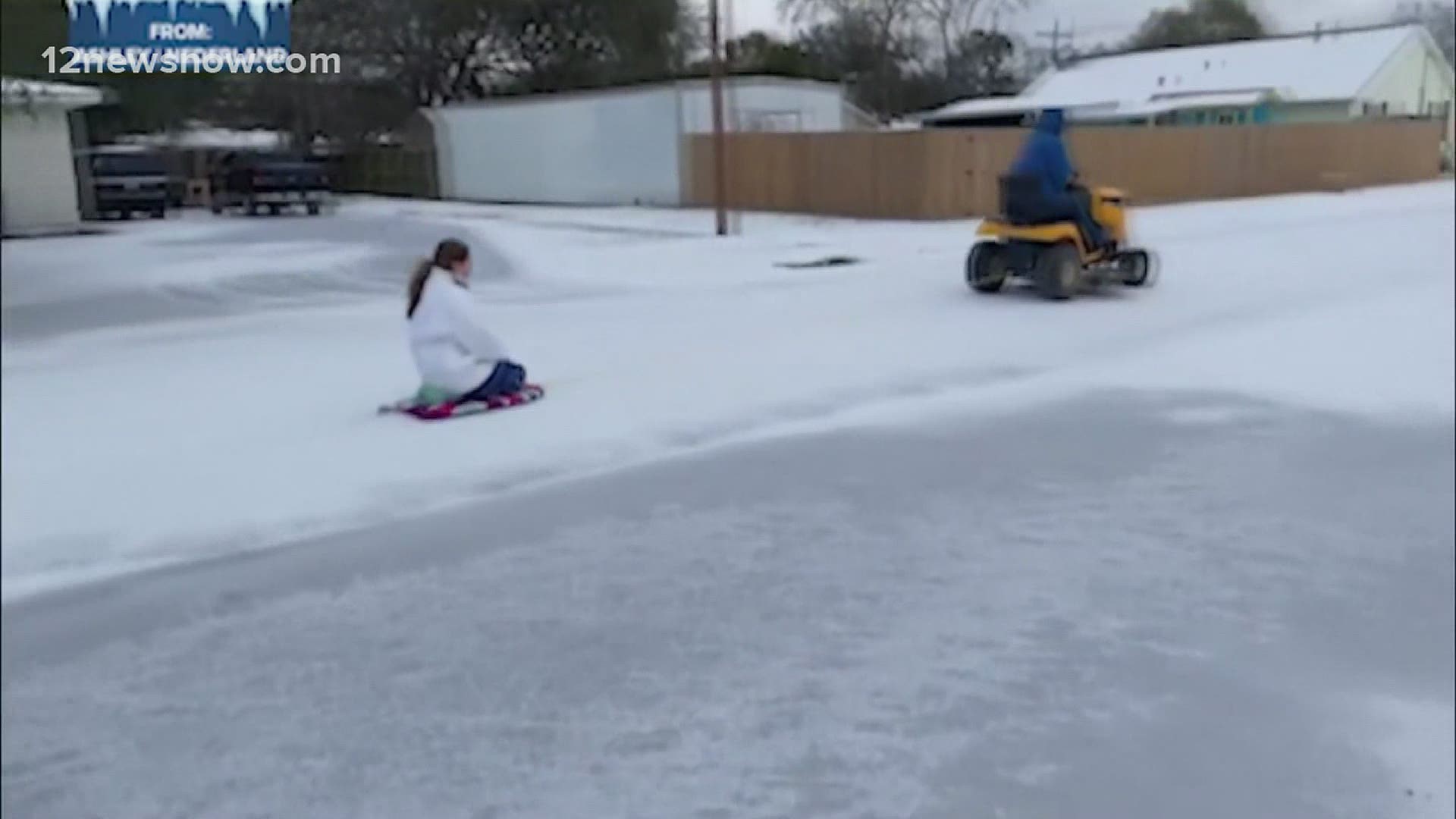 Family in Nederland sleds down the street with the help of a lawnmower