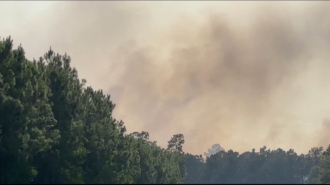 Firefighters fighting wildfire near Little Cypress